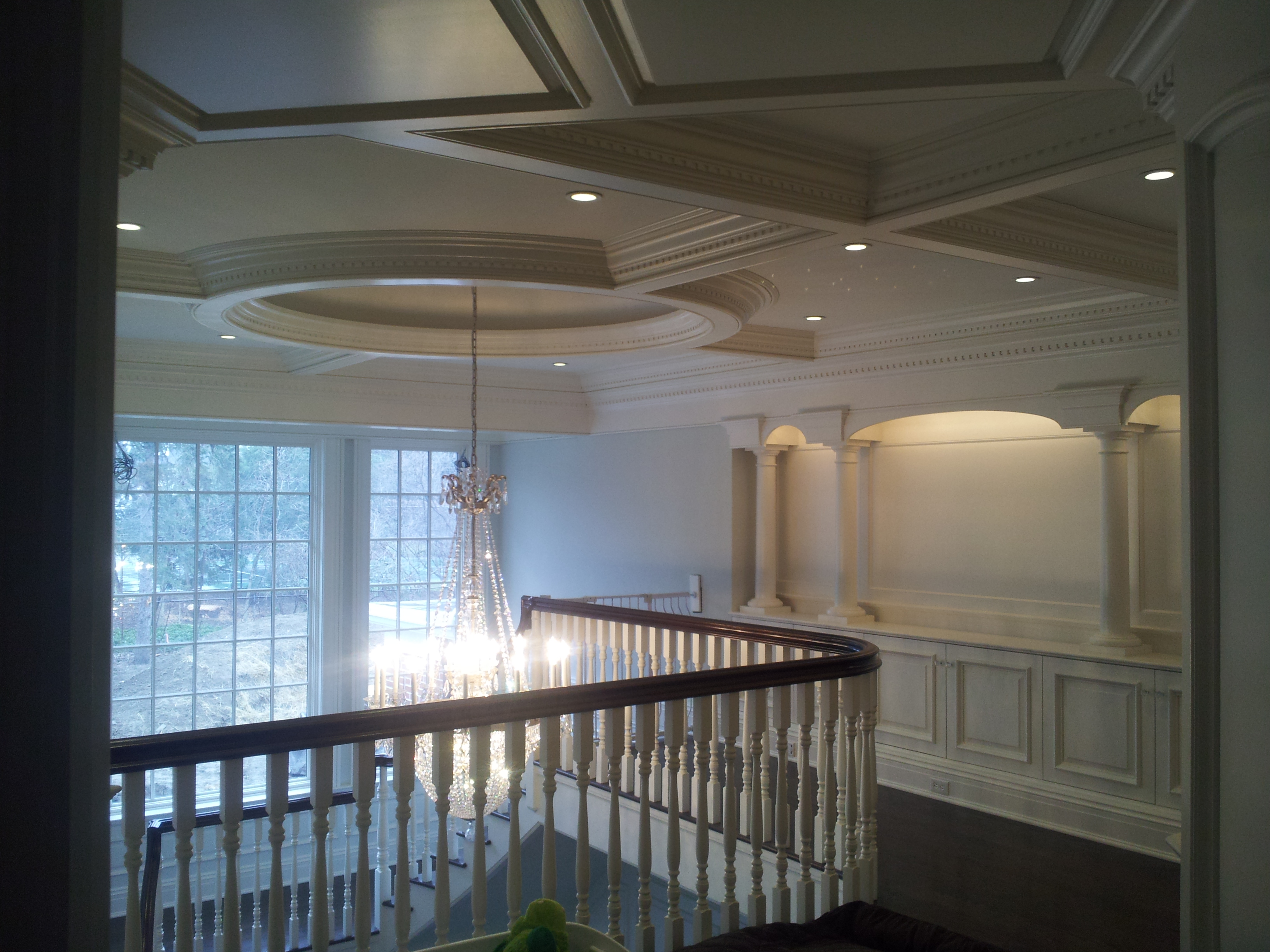 Elegant interior hallway with chandelier and recessed lighting